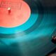 A detailed close-up view of a vintage vinyl record spinning on a turntable, capturing its nostalgic beauty.