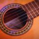 closeup photography of brown acoustic guitar