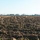 A close-up image of a freshly plowed farmland in springtime, ready for new crops.