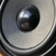 Detailed close-up of a modern speaker woofer cone showing texture and design.