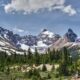 Capture of the majestic snow-capped Rocky Mountains in Banff under a sunny sky.