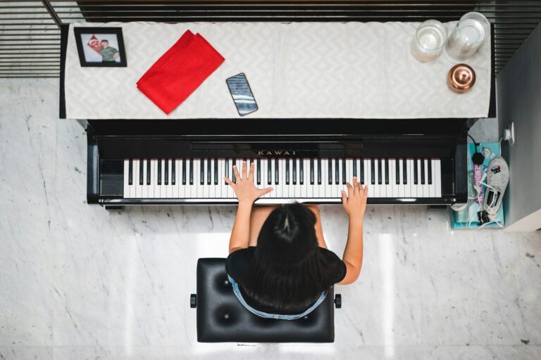 woman playing piano near white wall inside room